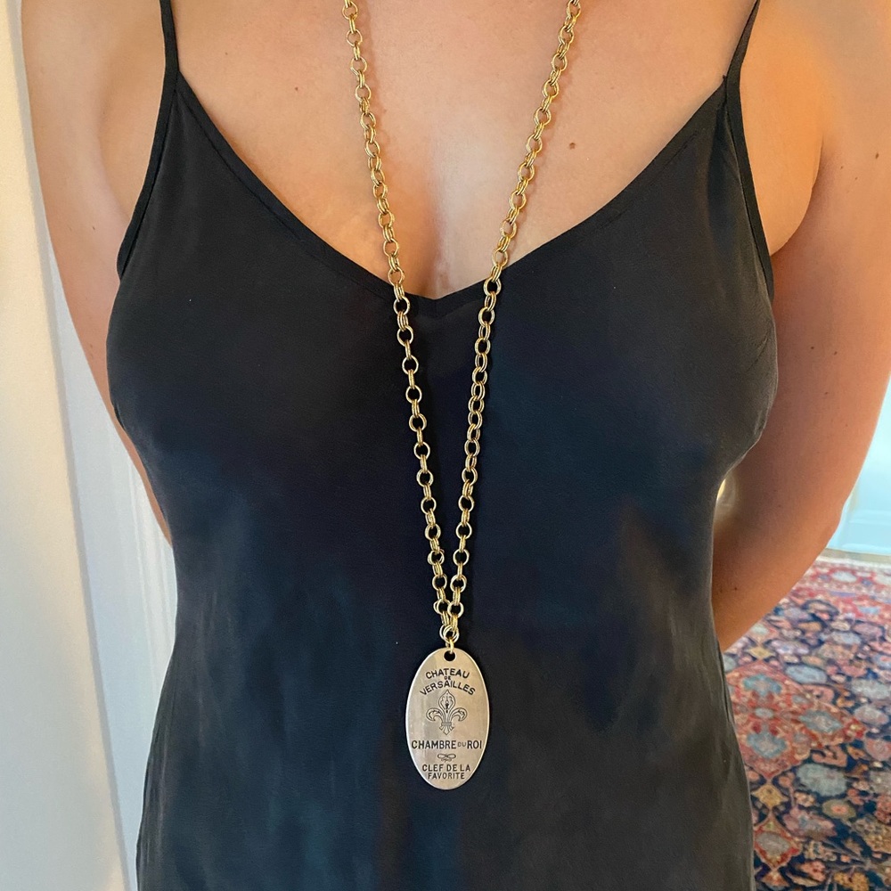 Long, brass chain with unique French pendant